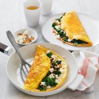 Fluffy Omelettes with Wilted Kale, Goat's Cheese and Pine Nuts