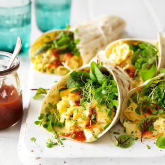 Vegetarian egg breakfast tacos in a soft shell taco with feta and fresh herbs