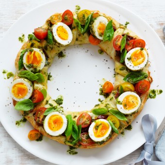 Christmas pastry wreath with pesto eggs and herbs