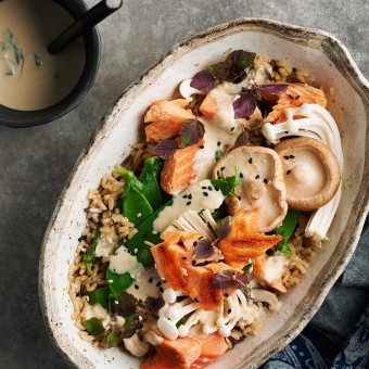 Healthy brown rice bowl with ocean trout and mushrooms