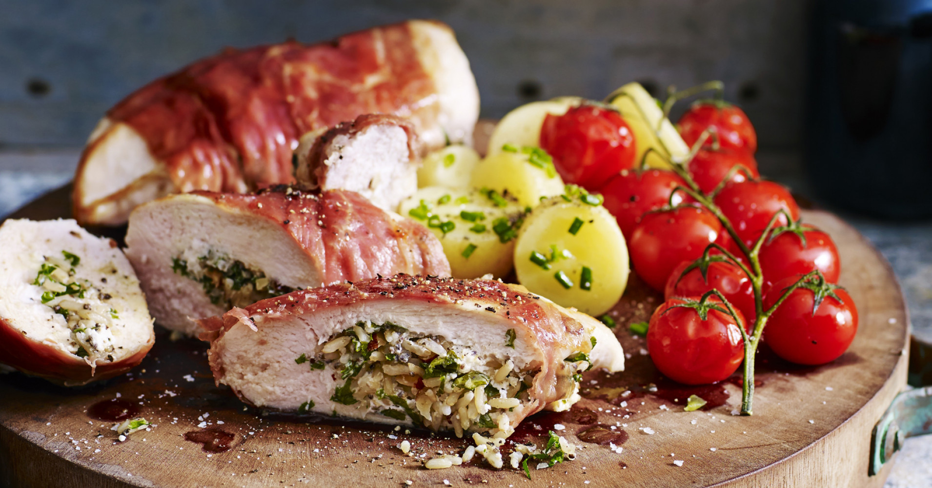 Prosciutto-Wrapped Chicken with Vine Tomatoes and Chat Potatoes Recipe | myfoodbook