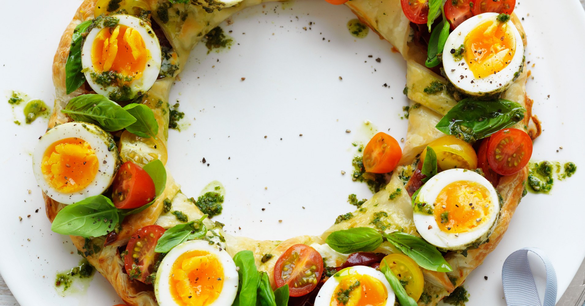 Herbed ricotta pastry wreath with pesto eggs