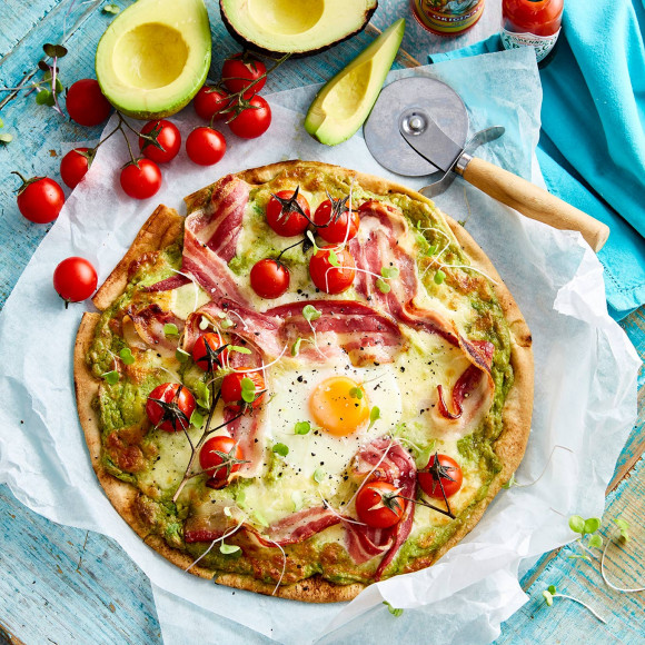 Breakfast pizza with egg, bacon and avocado