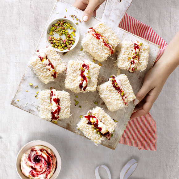White chocolate lamingtons with pistachios and raspberry jam