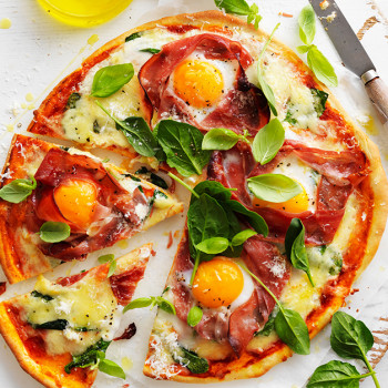 Delicious breakfast pizza with prosciutto and Egg at Easter