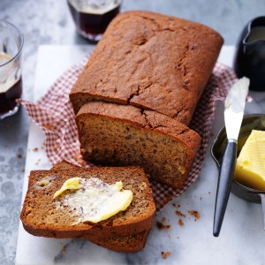 Classic banana bread recipe sliced with butter